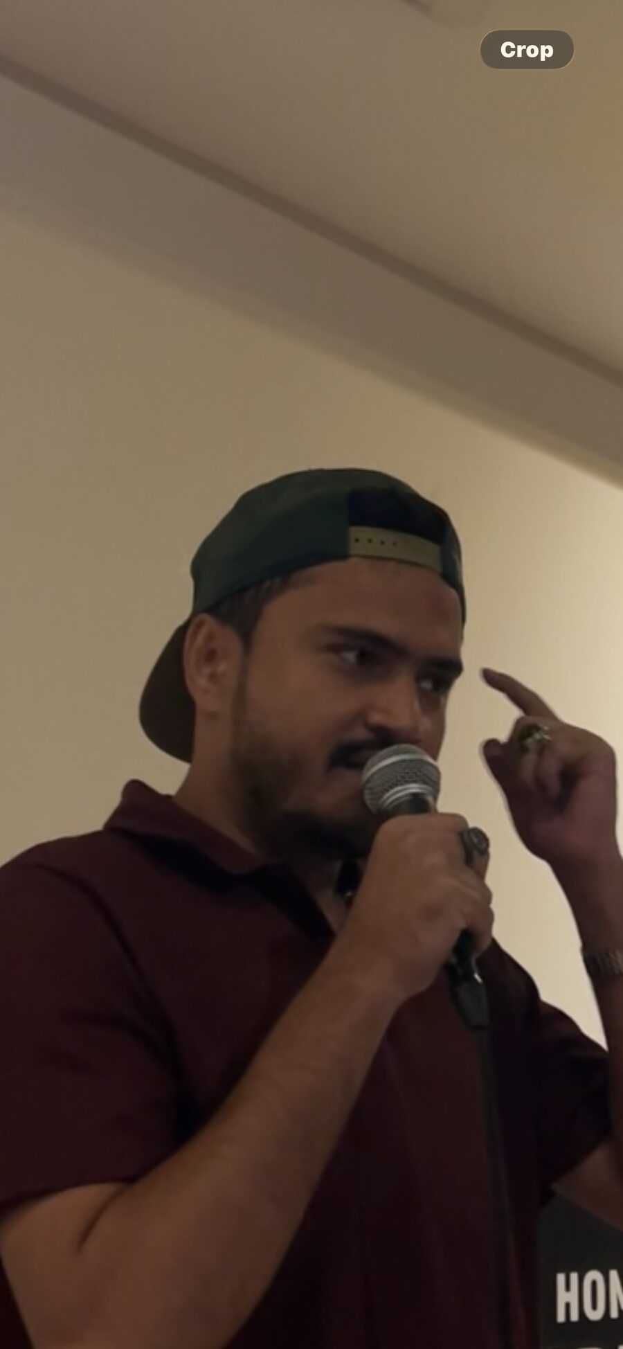 Abdullah AKJhaluk Khan performing on stage with a microphone